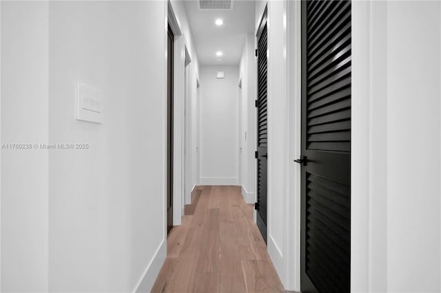 corridor with visible vents, recessed lighting, light wood-type flooring, and baseboards