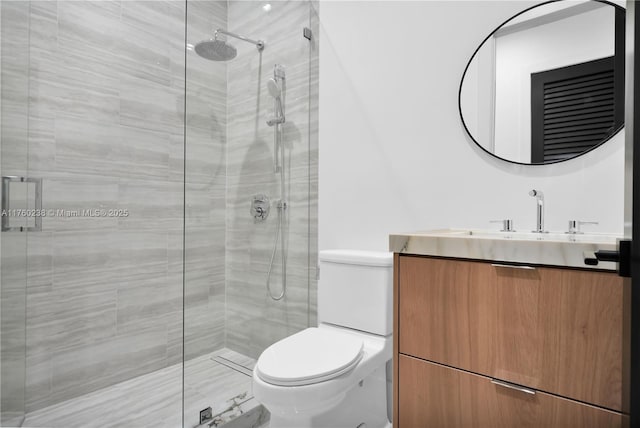 full bathroom featuring vanity, toilet, and a stall shower