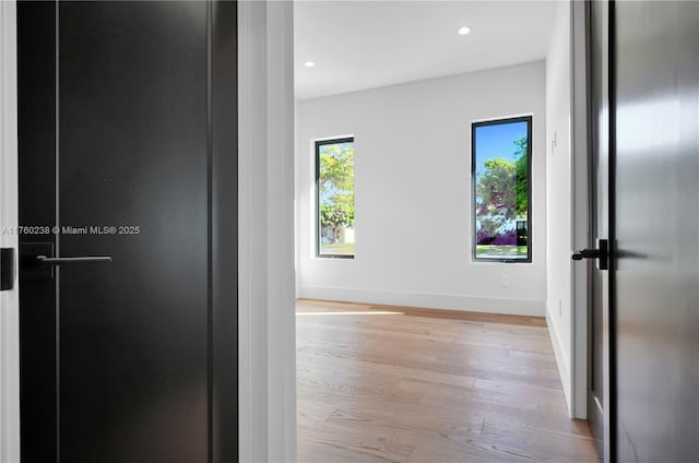 hall featuring recessed lighting, baseboards, and wood finished floors