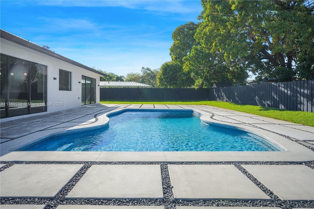 view of pool with a fenced in pool, a patio, a lawn, and a fenced backyard