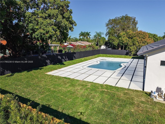 view of swimming pool featuring a yard, a fenced in pool, a fenced backyard, and a patio area