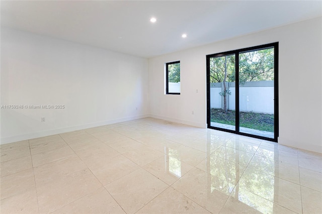 spare room featuring light tile patterned floors, recessed lighting, and baseboards