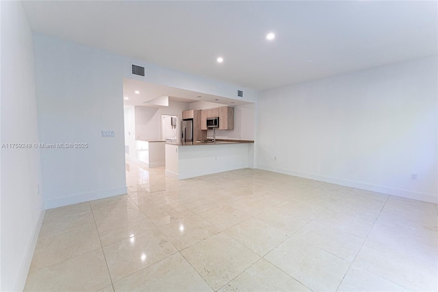 unfurnished living room with visible vents, recessed lighting, and baseboards