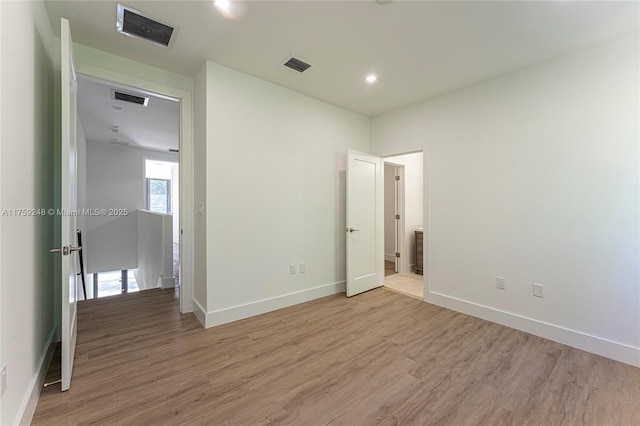 unfurnished bedroom with visible vents, baseboards, and light wood finished floors