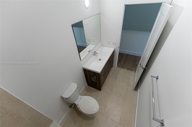 bathroom with tile patterned floors, toilet, vanity, and baseboards