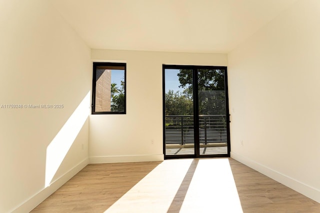 empty room with light wood finished floors and baseboards