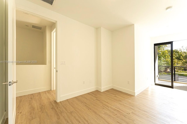 unfurnished room with light wood-style flooring, baseboards, and visible vents