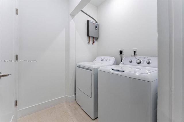 laundry area with light tile patterned floors, laundry area, baseboards, and separate washer and dryer