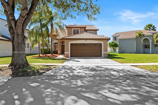 mediterranean / spanish-style house with a tiled roof, a front yard, stucco siding, driveway, and an attached garage