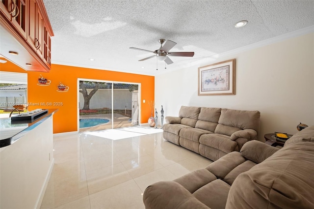 tiled living room with crown molding, baseboards, and a textured ceiling