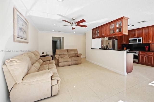 living room with light tile patterned floors, visible vents, crown molding, and a ceiling fan