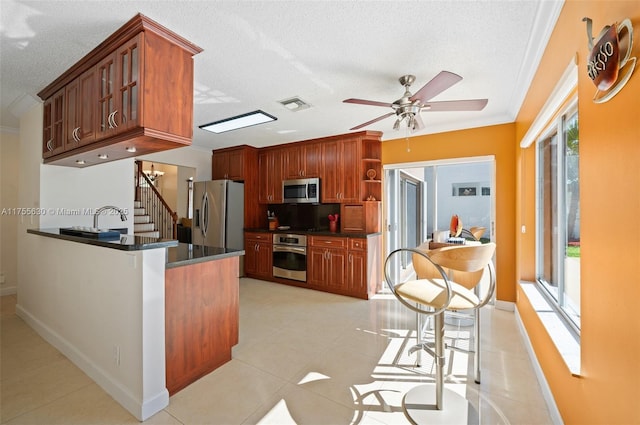 kitchen with light tile patterned floors, visible vents, open shelves, ornamental molding, and appliances with stainless steel finishes