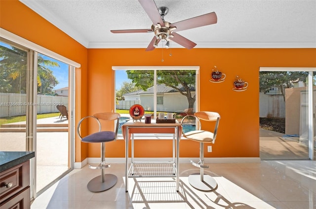 sunroom with a healthy amount of sunlight and a ceiling fan