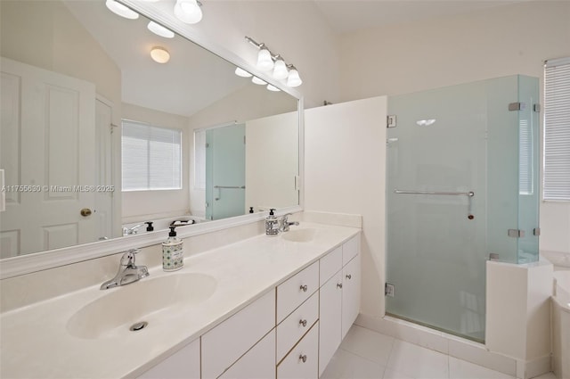 full bath with a bath, a shower stall, tile patterned floors, and a sink