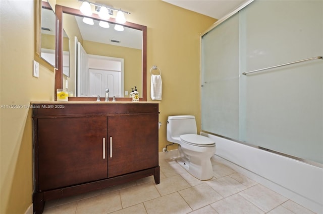 bathroom with visible vents, toilet, tile patterned floors, vanity, and enclosed tub / shower combo