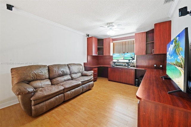 interior space featuring light wood finished floors, a textured ceiling, crown molding, and ceiling fan