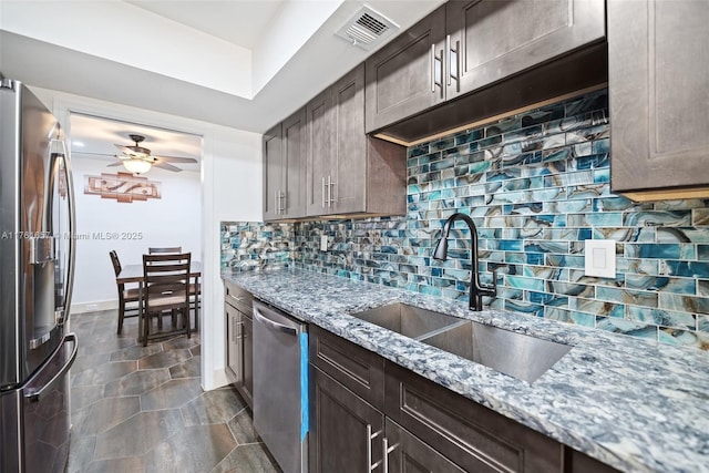 11696 NW 20th Dr Unit 11696, Coral Springs, FL 33071 - kitchen with appliances with stainless steel finishes, a sink, ceiling fan, tasteful backsplash, and light stone counters