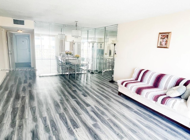 living area featuring wood finished floors and visible vents