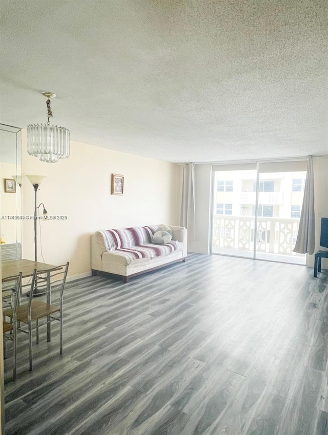 living room with a textured ceiling and wood finished floors