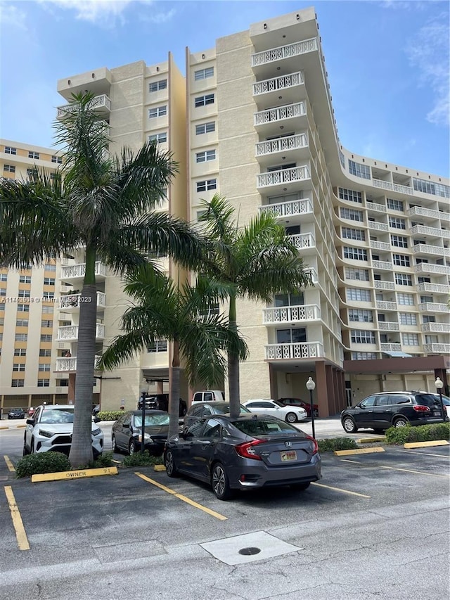 view of building exterior featuring uncovered parking