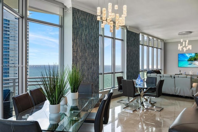 dining area featuring marble finish floor, a water view, an inviting chandelier, and ornamental molding