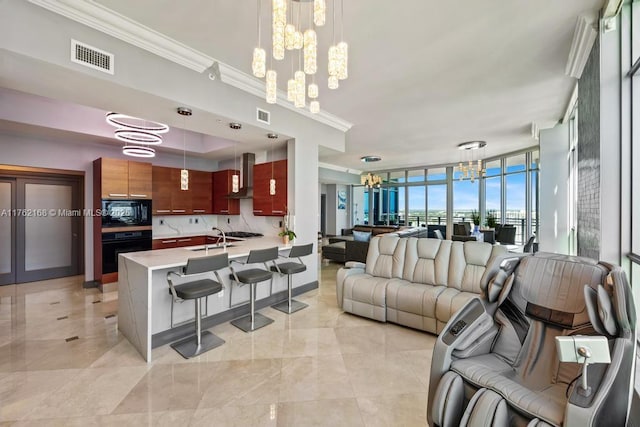 living room with an inviting chandelier, crown molding, and visible vents