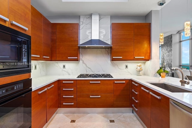 kitchen with modern cabinets, light stone counters, black appliances, wall chimney exhaust hood, and a sink