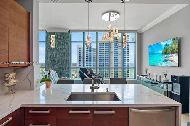 kitchen with pendant lighting, ornamental molding, a sink, light stone countertops, and dishwasher