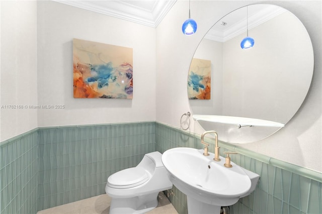 3535 S Ocean Dr Unit 2606, Hollywood, FL 33019 - bathroom with crown molding, wainscoting, a sink, toilet, and tile walls