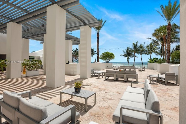 view of patio featuring a view of the beach, an outdoor hangout area, a pergola, and a water view