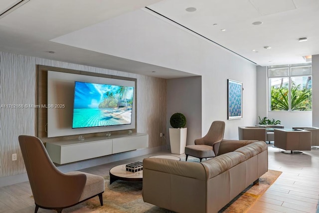 living area with light wood-type flooring and wallpapered walls