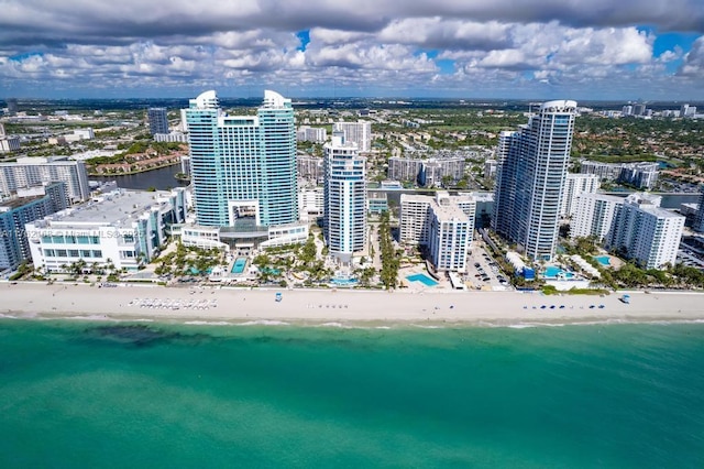 drone / aerial view with a view of city, a view of the beach, and a water view