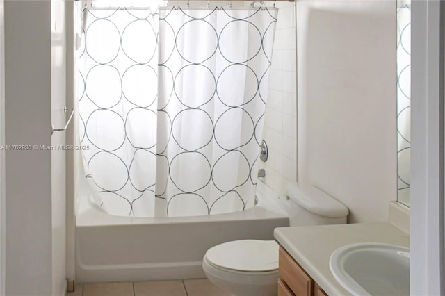 bathroom with tile patterned floors, shower / bathtub combination with curtain, toilet, and vanity