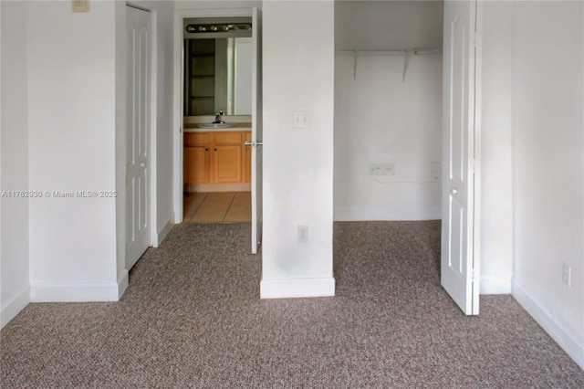 unfurnished bedroom featuring carpet and a sink