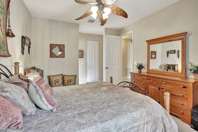 bedroom featuring a ceiling fan, visible vents, a closet, and carpet floors