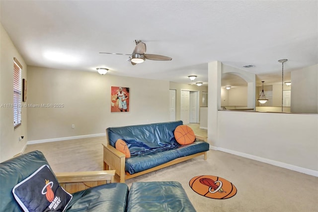 carpeted living area featuring visible vents, baseboards, and ceiling fan