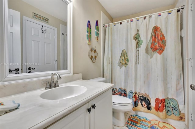 bathroom with vanity, curtained shower, and toilet