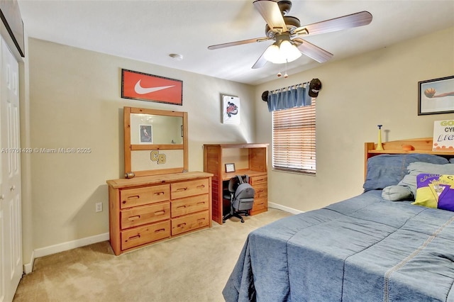 bedroom with light carpet, a closet, and baseboards