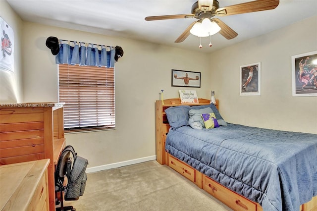 carpeted bedroom with baseboards and a ceiling fan