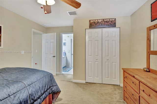 bedroom with visible vents, light carpet, a closet, and ceiling fan