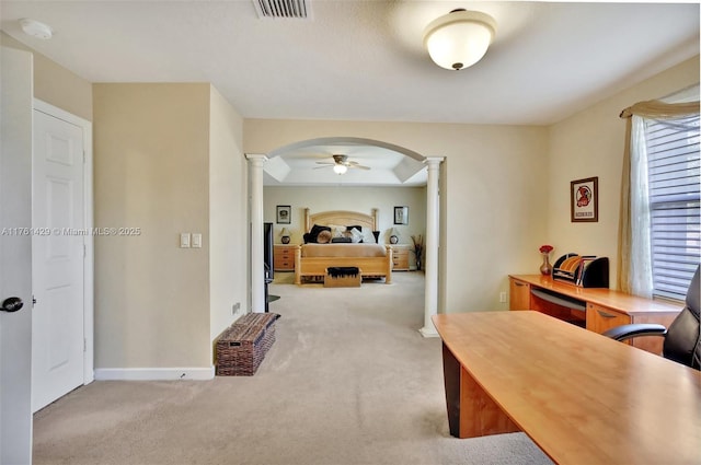 office area featuring arched walkways, carpet floors, and decorative columns