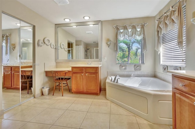 full bath with vanity, tile patterned floors, a garden tub, and a shower stall