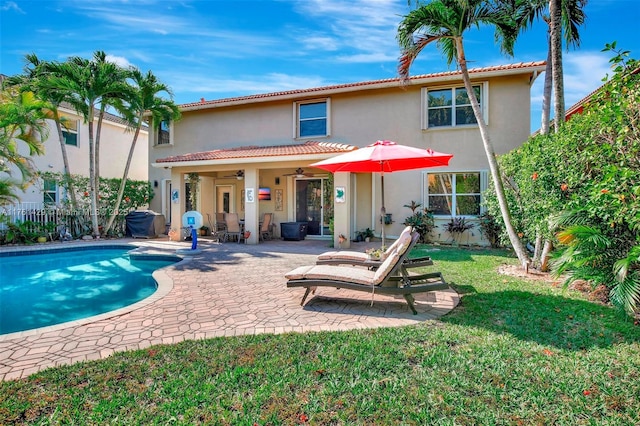 back of house with stucco siding, a patio, a ceiling fan, and fence