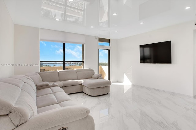 living room with recessed lighting and marble finish floor