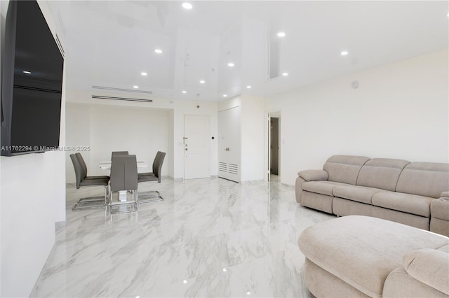 living area featuring recessed lighting and marble finish floor