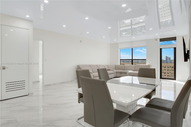 dining space with recessed lighting and marble finish floor