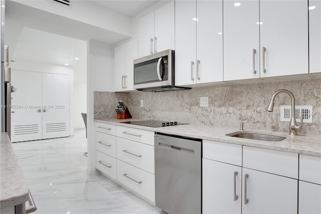 kitchen featuring a sink, marble finish floor, appliances with stainless steel finishes, and white cabinetry