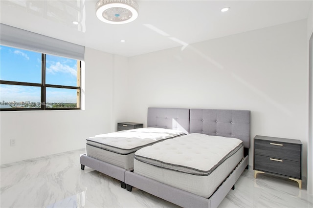 bedroom with recessed lighting and marble finish floor