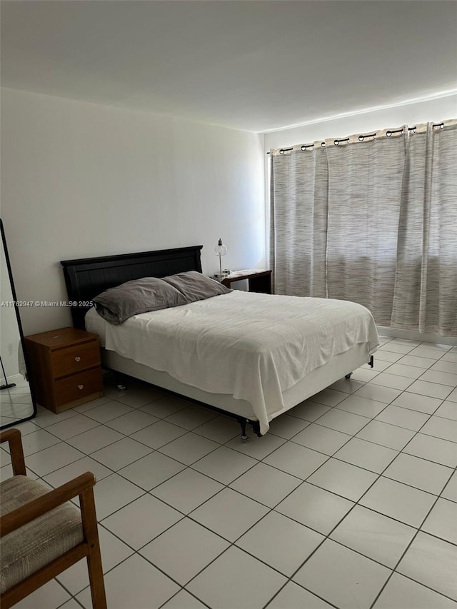 bedroom featuring light tile patterned flooring