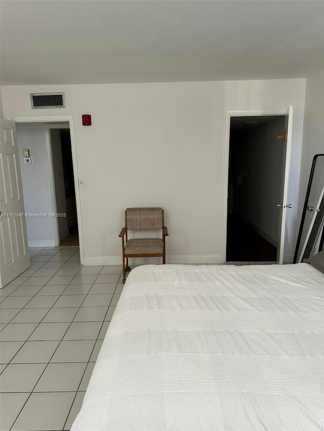 bedroom with light tile patterned floors, baseboards, and visible vents